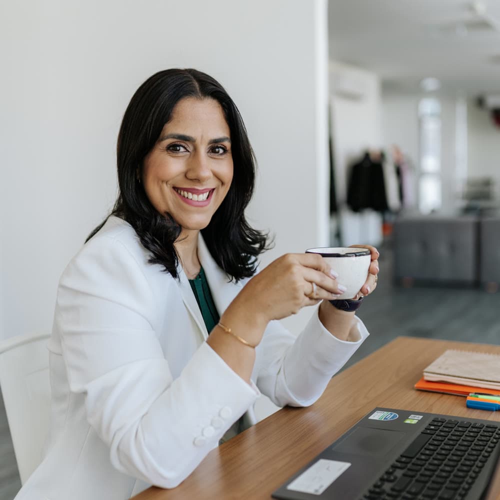 Taís Albuquerque em uma pausa de trabalho, com o laptop na mesa